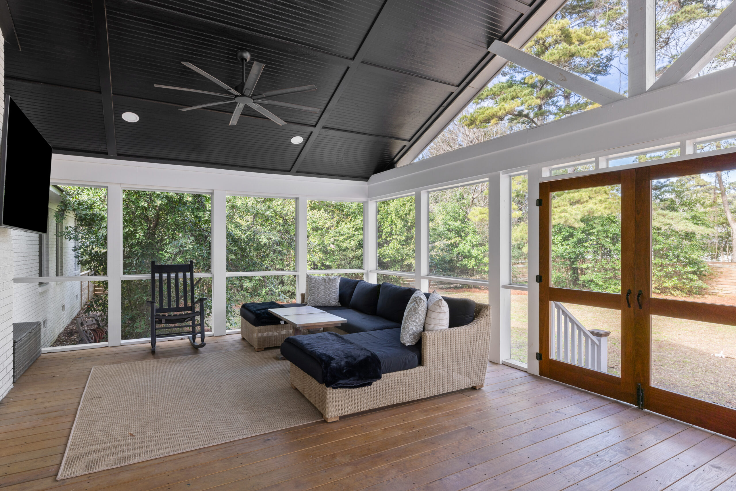 Screened porch overlooking a wooded yard