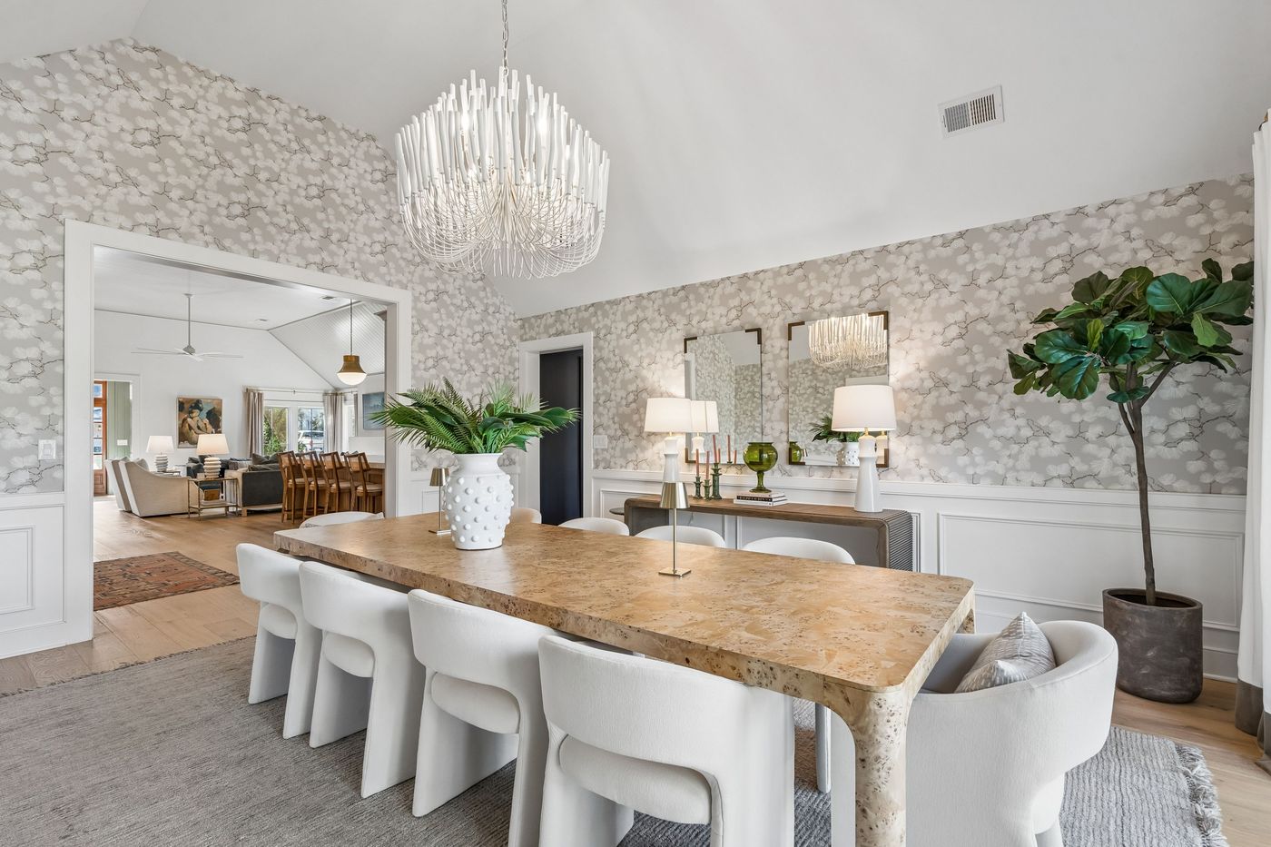 Dining room with floral wallpaper and burl table