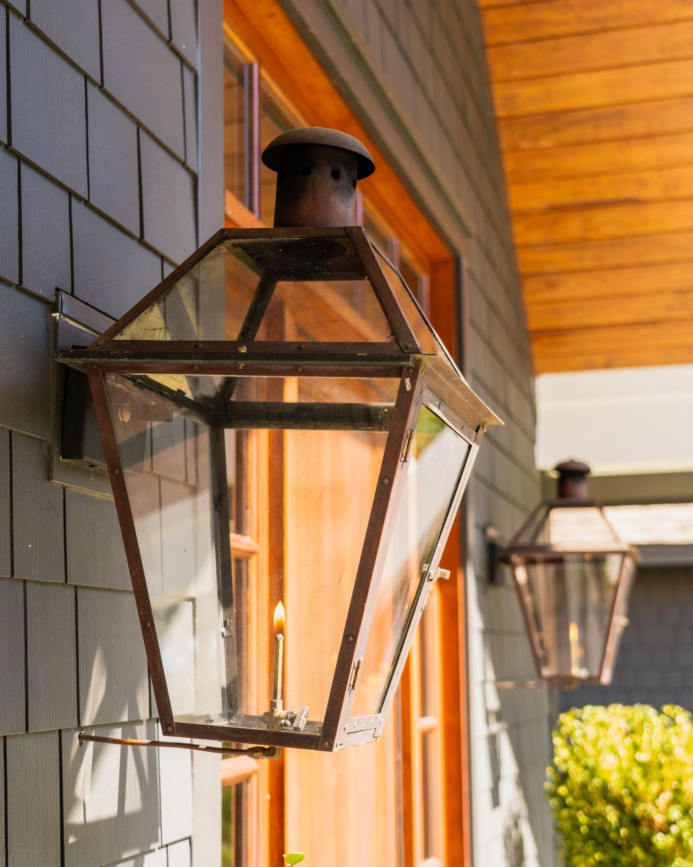 Copper gas lanterns on shingle siding